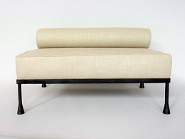Hocker. Patined iron, with matras and role.